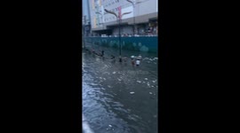 Filipinos show resilience during typhoon Carina in flood-filled underpass