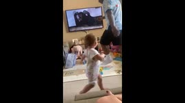 Adorable toddler marching along to The Elephant Song makes dad join in too