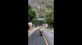 Dangerous freestyle action in indonesia by a pair of teenagers, their heads almost touching the asphalt of the highway