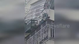 China: Worker Electrocuted, Rescued from Precarious Position on Security Window