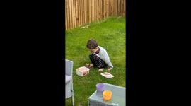 Little boy sneaks ice cream outside while dad is unaware