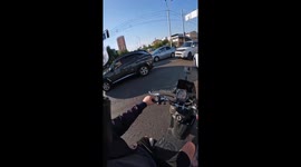 Driver cuts off motorcyclist, crashes into bus in Almaty, Kazakhstan