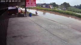 Pickup truck overturns on slippery road after monsoon downpour in Thailand
