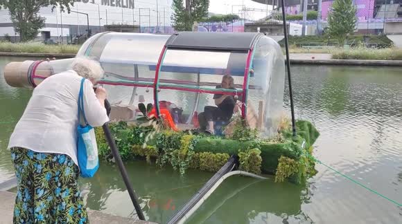 Artist seals himself inside large plastic bottle outside Stade de France during Paris Olympics