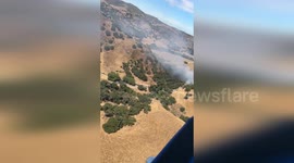 USA: Helicopter Footage Captures Firefighters' Efforts in Santa Maria Vegetation Fire