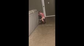 Little girl tries to walk in cowboy boots with her uncle’s guidance