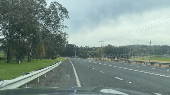 Giant Dump Truck being escorted by multiple police vehicles in Australia