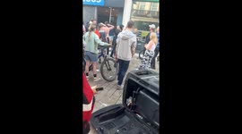 Moment protesters smash into Greggs store and begin looting