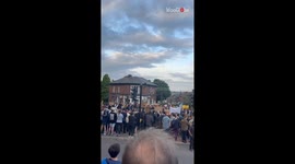 Large crowd of anti-racism protesters protects a visa site against rioters in Sheffield
