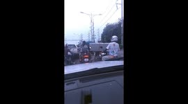 Motorcycle rider struggles carrying huge fridge on back seat