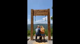 Kissing Couple Slowly Fall From Heavenly Swing