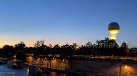 Crowds gather to watch the Olympic couldron rise into the air for the last time in Paris