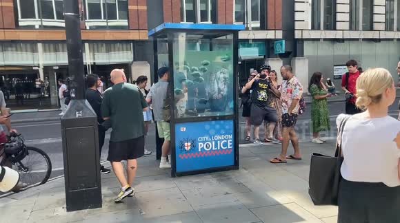 Crowds gather to see the new Banksy piece in the City of London