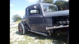 Classic old car looks like a luxurious ride with red seats inside