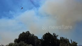 Firefighting helicopter heading to the forest fire in the northern suburbs of Athens, Greece