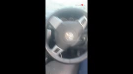 Car stuck in bushes and heavily damaged after unexpected pothole incident