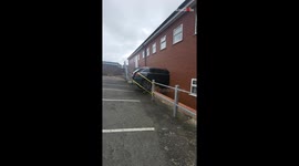 Startling accident: Car embeds in a building wall after speeding mishap