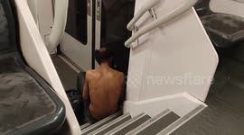 Half-dressed homeless person in Parisian transports.  Barely have the Paris Olympic Games 2024 ended, the homeless people hidden or evicted by the authorities for the sportive events’ period are visible in the capital again.(15 aug 2024).  Station: La Def