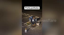 Man disgruntled with state of town's roads fills potholes - with flowers