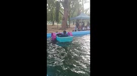 Children ages 10, 7 and 4 year old cruising their water boat at the children park and zoo