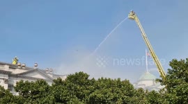Firefighters on platforms seen tackling blaze on the roof at Somerset House