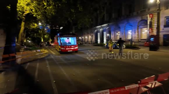 Firefighters start to get ready to depart from Somerset House after putting out the fire