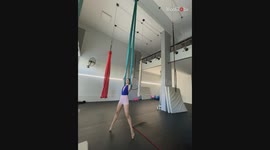 Twisting in the air: Girl performs an aerial sling with grace and joy