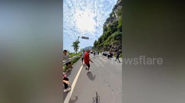 Tourists flee as rocks plummet from massive waterfall