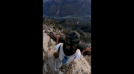 Adventurer takes leap from cliff on carpet in France