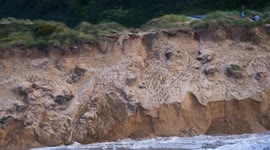 Hurricane Ernesto Tail end hits UK, Spectators perch on Crumbling Sand cliffs. Crantock, Cornwall, UK