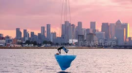 Stunning sunset finale of aerial performance atop a massive 2.5 tonne block of ice suspended over Royal Docks in London
