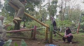 People fall off balance swings in Kajen, Indonesia