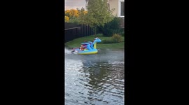 Kids Have Fun in Flooded Street