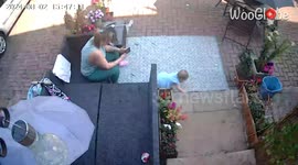 Wind blows umbrella into mom while daughter plays on rug