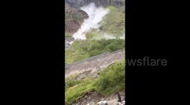 Bystanders watch on in shock as huge boulders crash down mountain at tourist hotspot in China