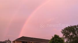 Double rainbow appears in pink sky following thunderstorm