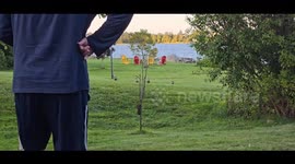 Man calls a family of wild ducks, a mama and her 4 adolescents for food and they come running.