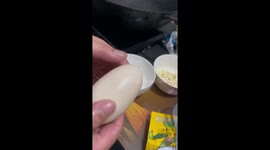 Chinese woman in shock as she cracks egg to reveal another egg inside