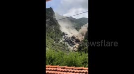 Wall of dust descends down mountain after landslide triggered in China