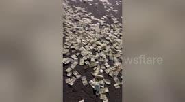 Cash spills onto road and kind locals rush to help driver collect the notes