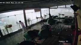 Glass doors shatter in stormy weather as residents attempt to secure panels