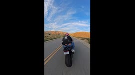 Biker hits soil on road barrier in Bakersfield, California