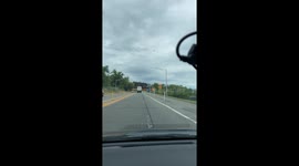 Motorist tries their best to warn truck driver of low bridge, but it's too late