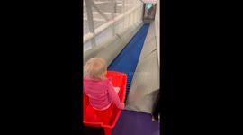 Child slides down conveyor belt at Uppsala bus factory