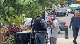Altercation Between A Masked Man With Cameras And One Of The Pro Palestine Protesters With A Megaphone in Downtown Oakville, Ontario, Canada