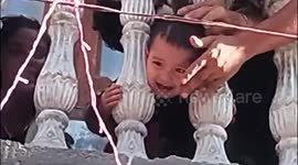 Child with head stuck between concrete balcony posts rescued by neighbours