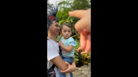 Young boy's comical reaction when forced to acknowledge the Palm Cockatoo on man's shoulder