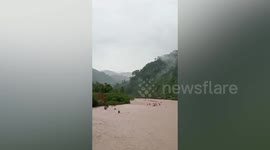 Six villagers catching shrimp stranded in rising river in Indonesia