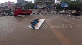 Person enjoys floating on foam in Pune flood waters