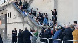Anna Wintour is forced to abandon her car and made to go through the public to get to the Burberry show due to protestors from Petra holding up her car